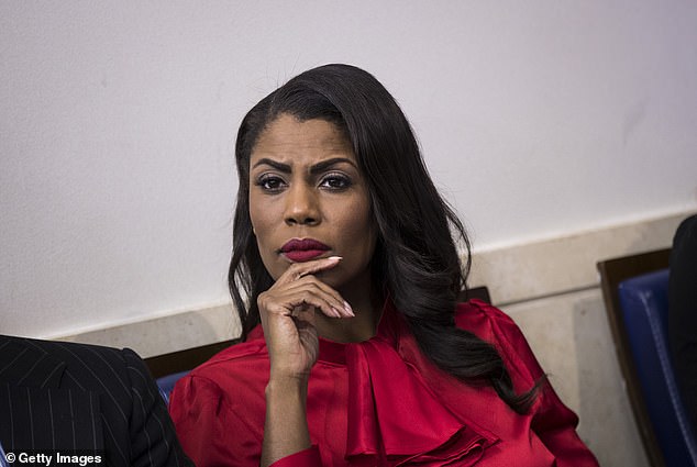 Omarosa is photographed in the White House briefing room in October 2017.  Trump said he hired her as an 