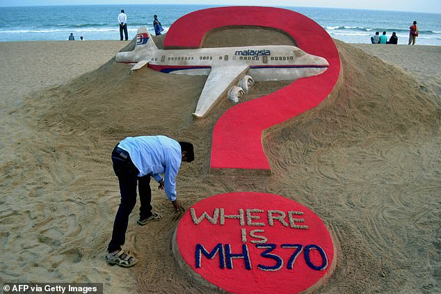 Indian sand artist Sudarsan Pattnaik creates a sand sculpture of the missing Malaysia Airlines flight MH370 at Puri beach in the eastern state of Odisha on March 7, 2015