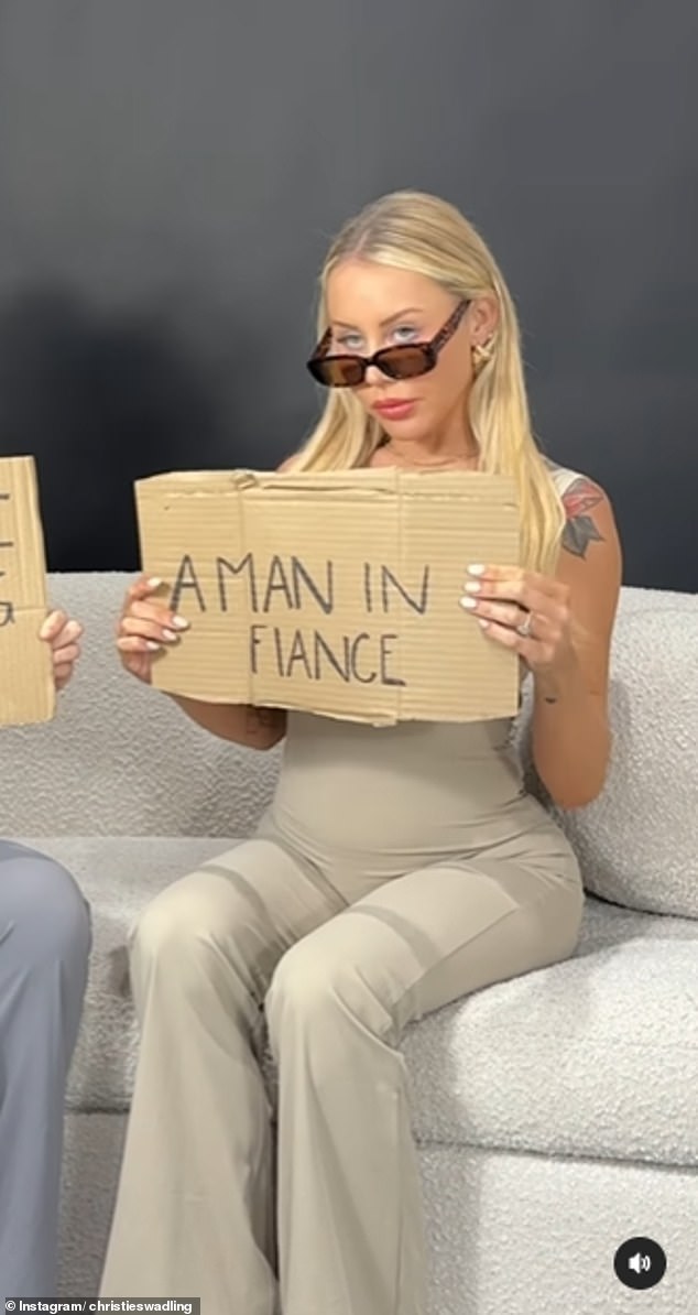 The YouTube star hops on a recent TikTok trend, writing on a piece of cardboard that she's 
