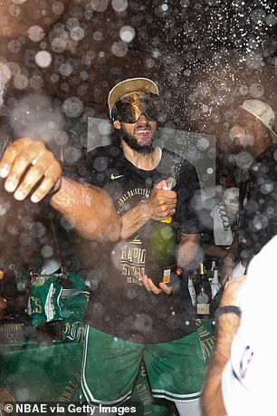 Derrick White couldn't wait to start spraying the champagne