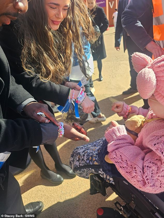 Other Taylor Swift fans show Florence their friendship bracelets during the concert