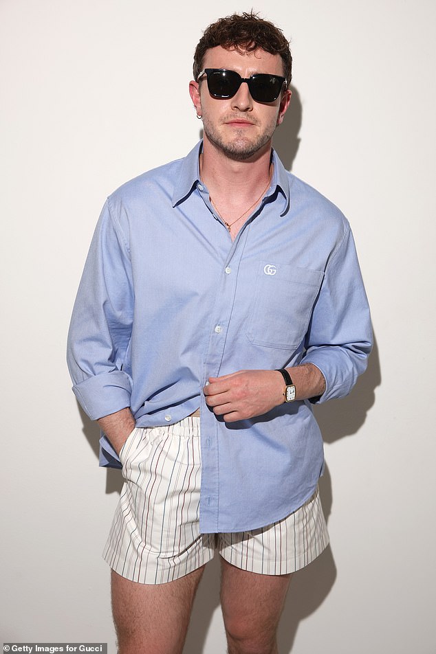 The star (pictured) – who appeared in a Gucci campaign in October 2023 to promote their 1953 Horsebit Loafer – opted for a light blue shirt with the brand's logo, which he only half-buttoned.
