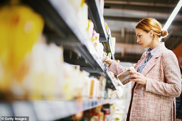 A woman is pictured shopping for gluten-free products (image)