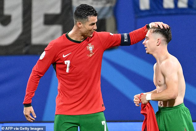 Cristiano Ronaldo (left) was one of the first to congratulate the youngster on his late winner