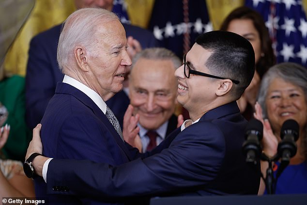President Joe Biden (left) embraces Javier Quiroz Castro (right) at the White House on Tuesday.  As the president marked 15 years of DACA, which gave Castro citizenship, he rolled out a plan to help spouses of U.S. citizens who entered the U.S. illegally find a way to become citizens.