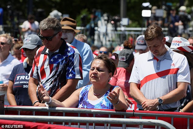 Trump spoke Tuesday, June 18, at a rally in Racine, Wisconsin – just 30 miles south of Milwaukee.  Pictured: Rallygoers pray ahead of Trump's arrival