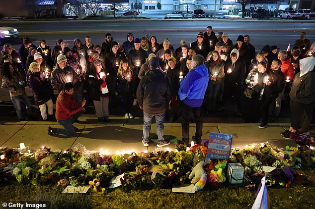 People held a vigil at a makeshift memorial near the Club Q nightclub the night after the horror shooting