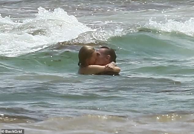 They mirrored the famous scene as they packed on the PDA and shared a steamy smooch in the ocean
