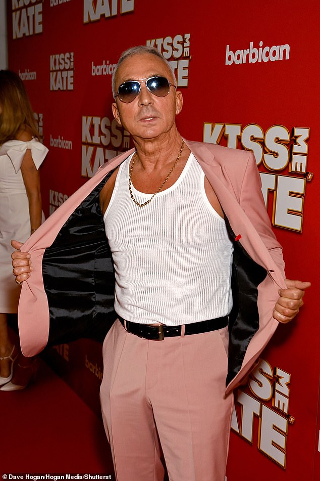 He also wore aviator sunglasses and a silver chain as he posed on the red carpet