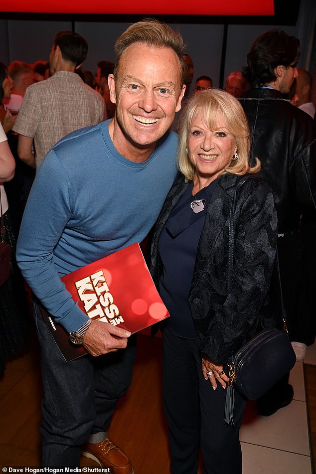 Jason Donovan opted for a casual look in a blue sweater and dark pants as he posed for a photo with Elaine Paige