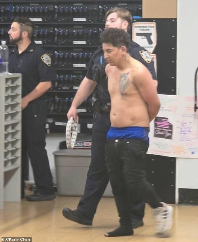 An image showed the shirtless suspect being led away by police wearing only one shoe after the fight with a group of locals