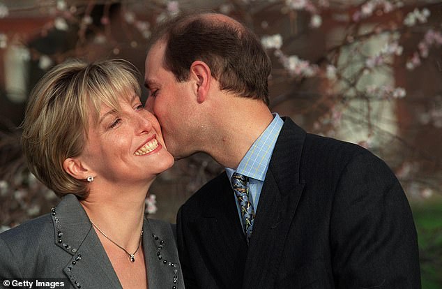 Sophie Rhys-Jones smiles broadly as she is kissed on the cheek by Prince Edward during their engagement announcement in January 1999