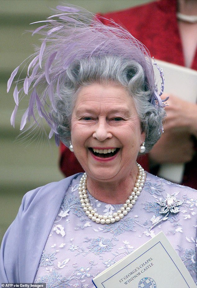 The late Queen Elizabeth wore an embroidered lilac dress and a matching feathered fascinator – even though the couple had advised guests against wearing hats