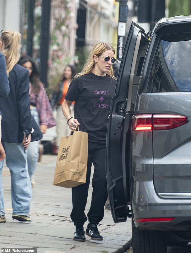 The 37-year-old singer wore a black T-shirt with a slogan print and matching wide sweatpants