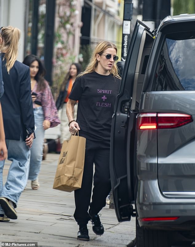 She paired a pair of black and white Adidas sneakers with the casual ensemble and further accessorized the look with a pair of oval shades.