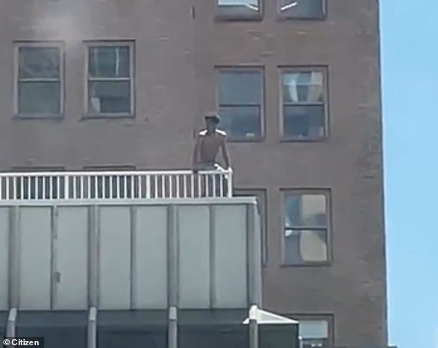 Witnesses caught the maniac on camera throwing a wooden chair over the edge before it crashed into the scaffolding below as pedestrians scrambled to safety