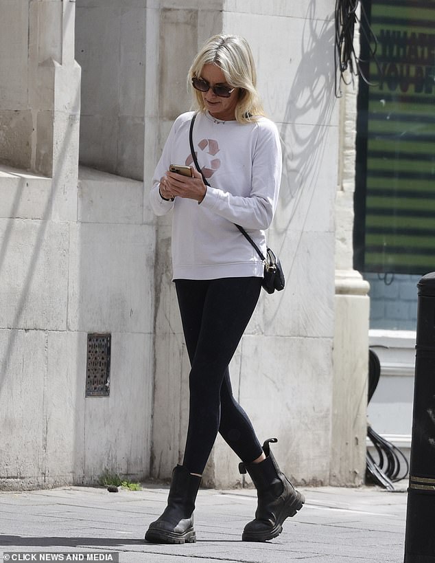 The star was noticeably focused on her phone as she headed out for a stroll in the London sunshine