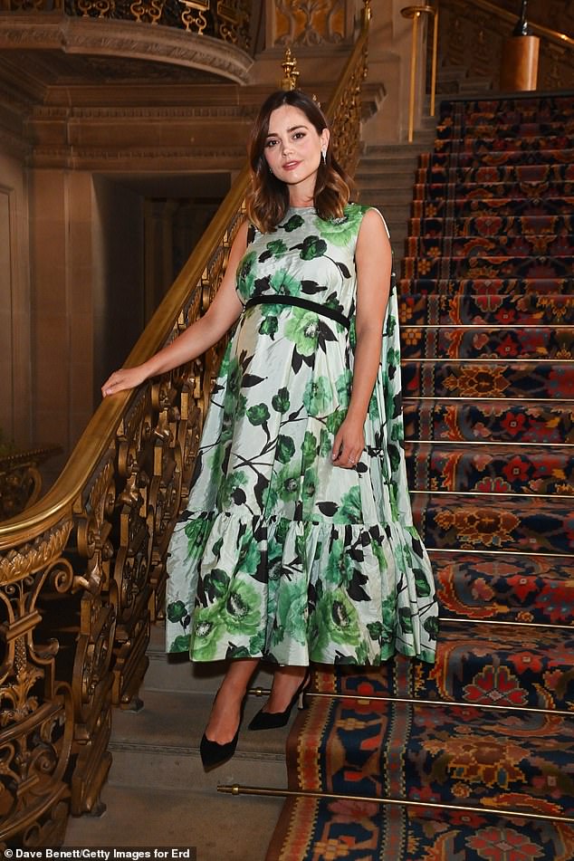 Jenna looked stunning in a green floral dress and cradled her bump as she posed for photos at the historic site of Chatsworth House