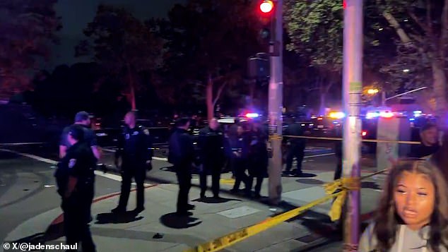 At least four people were taken to hospital with gunshot wounds after the incident at Lake Merrit Wednesday evening, shortly before 9 p.m.  In the photo: Dozens of police officers place a cordon around the scene