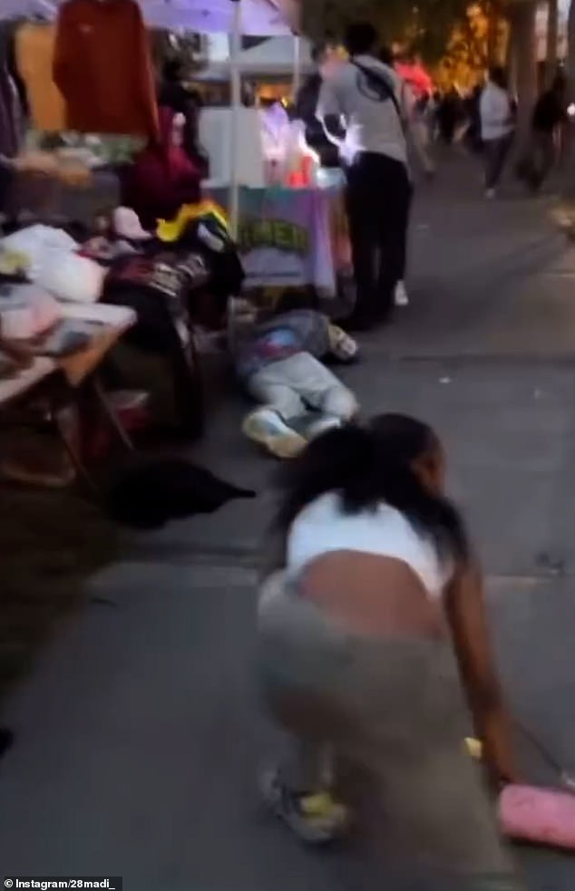 In another video, a woman was forced to kneel close to the ground as she tried to get to safety from the scene