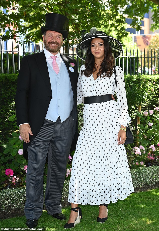 The DIY SOS star, 61, didn't hold back with his fashion choices, opting for a statement black top hat and matching long black blazer jacket