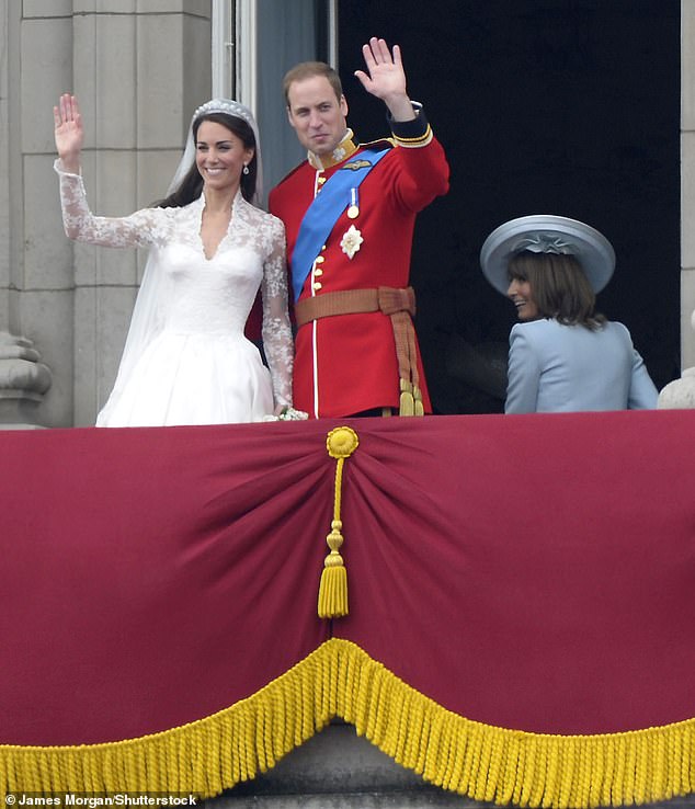 Kate and Prince William wave to the crowd from the balcony of Buckingham Palace on their wedding day, as Carole Middleton beams next to them