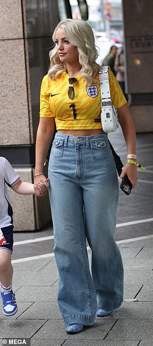 She paired a cropped England shirt with wide-leg trousers