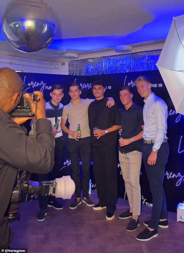 Guests were seen posing with the birthday boy against a personalized backdrop for a photographer