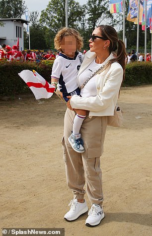 Lauryn carried Kairo - who was waving an English flag - in her arms as she arrived at the stadium