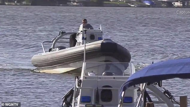 Police investigate the scene of the fatal jet ski accident on Lake Marie