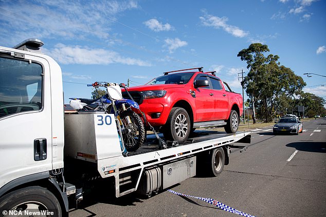 The alleged victim's red Ford Ranger is pictured being towed away on Thursday