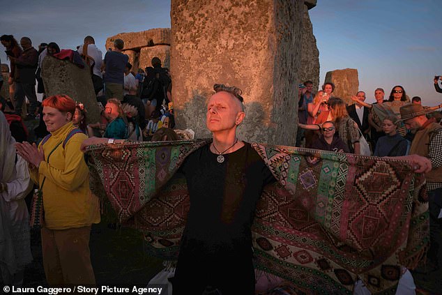 Revelers gather at Stonehenge, Wiltshire, the evening before the summer solstice