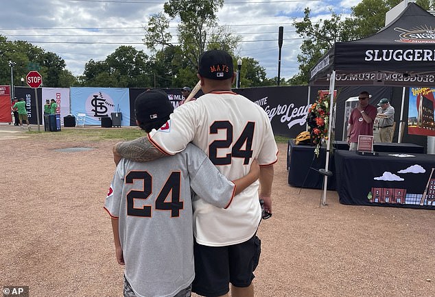 Eddie Torres, right, and son Junior, from California, wearing San Francisco Giants uniforms with Willie Mays' number 24 on the back