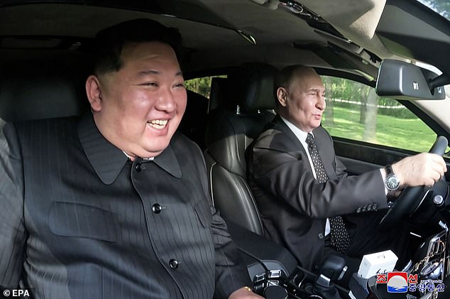 Russian President Vladimir Putin drives North Korean leader Kim Jong Un in an Aurus limousine in Pyongyang, North Korea, June 19, 2024