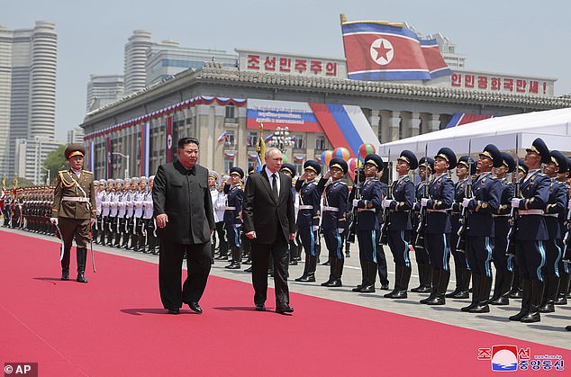 Putin and Kim Jong Un assess a guard of honor during the official welcome ceremony at Kim Il Sung Square in Pyongyang, North Korea, on June 19