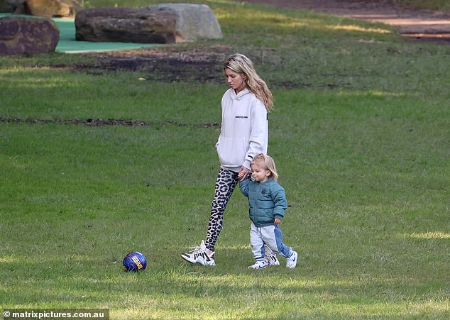 The pair were casual and cool as they played in a park in the Sydney suburb of Vaucluse, with mum Tegan wearing a white Barcelona hoodie.