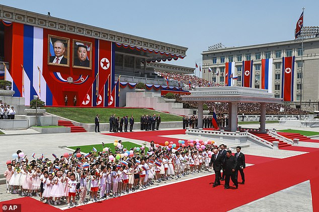 Russian President Vladimir Putin, left, and North Korean leader Kim Jong Un, right foreground, attend the official welcome ceremony at Kim Il Sung Square in Pyongyang, North Korea, on Wednesday, June 19, 2024