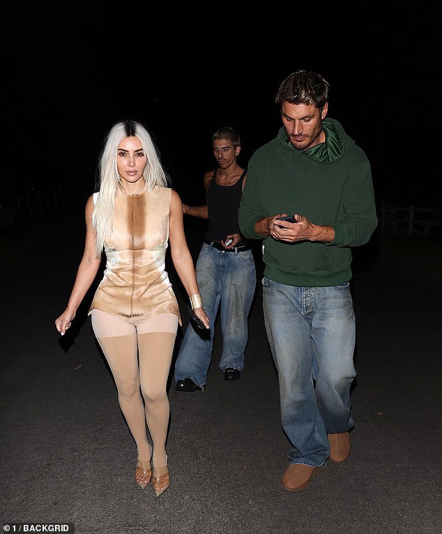 The SKIMS mogul donned a racy illusion dress with bizarre matching nude leggings as she headed out for the evening