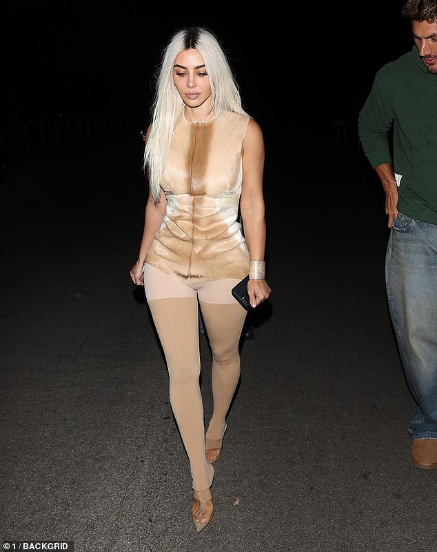 Kim accessorized her outfit with striking nude perspex heels which completed the bizarre outfit