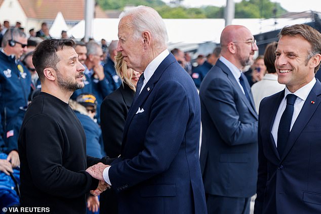 Other world leaders there on June 6 included US President Joe Biden (center) and his French counterpart Emmanuel Macron (right)