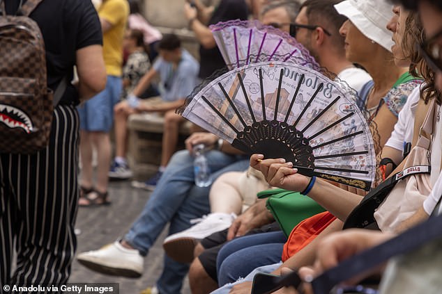 Tourists try to cope with the heat as the air temperature on the streets of Rome reaches 42 degrees Celsius