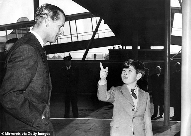 Prince Philip was seen with his son Prince Charles in 1956 as he prepared to leave for his Commonwealth tour