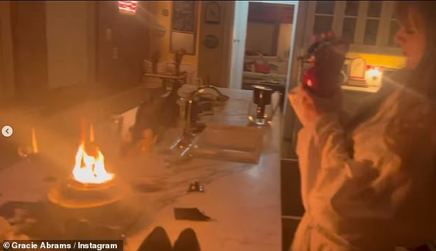 Taylor - dressed in a white dress - was seen picking up the fire extinguisher as the stunned star said: 'What do I do about this!'  I think we're dying!'