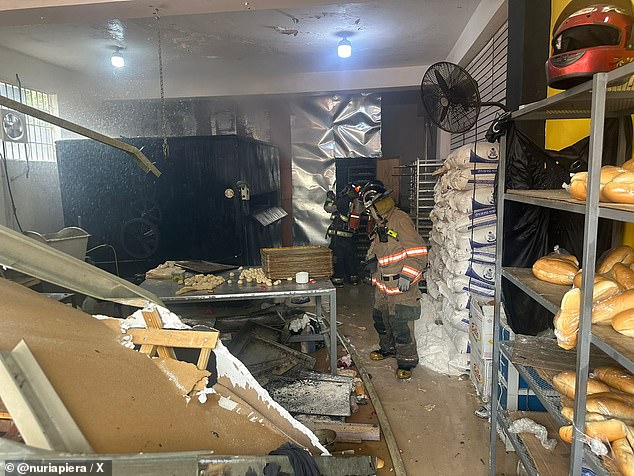Firefighters investigate the destruction at a bakery in La Vega, Dominican Republic, after an oven exploded due to a gas leak.  Three employees, a five-year-old girl and a firefighter were treated for burns