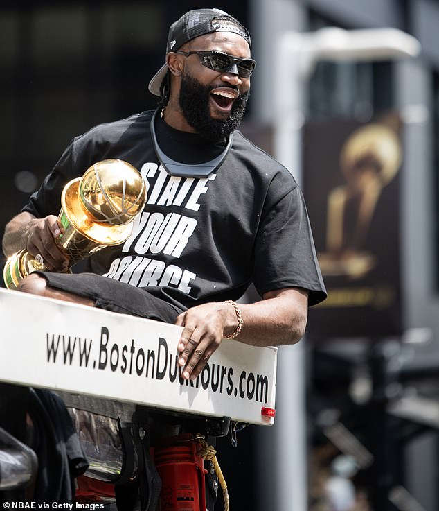 Finals MVP Jaylen Brown boarded his duck boat with a trophy and a “State your source” shirt