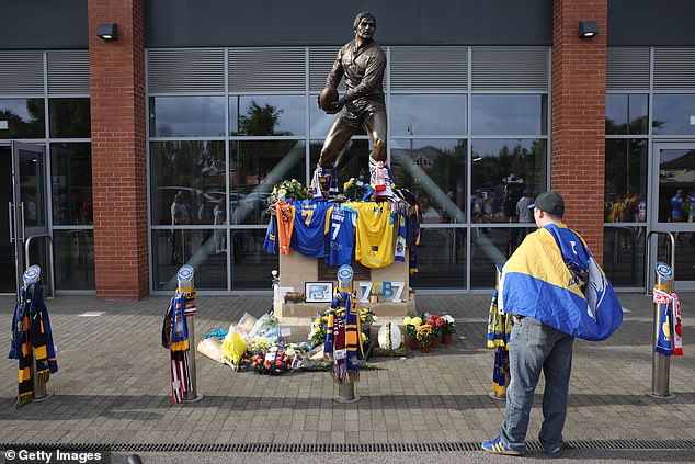Shirts, flowers and scarves were left outside the ground as supporters paid their respects