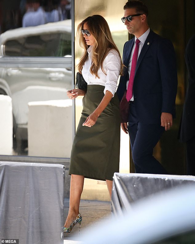Melania Trump wore a green summer skirt, a white shirt with rolled up sleeves and her signature stiletto heels