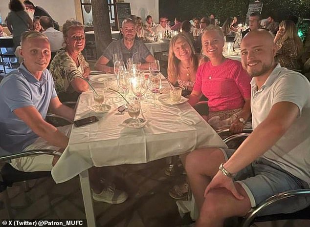 Ten Hag (third from left) was on holiday when club officials landed to ask him to stay