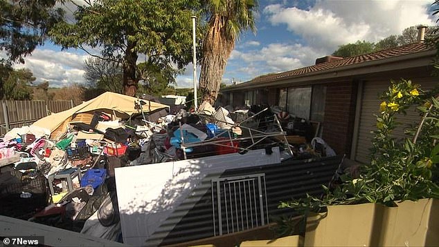 Residents say the shocking hoarding (pictured) around the house is putting their safety at risk and something must be done quickly
