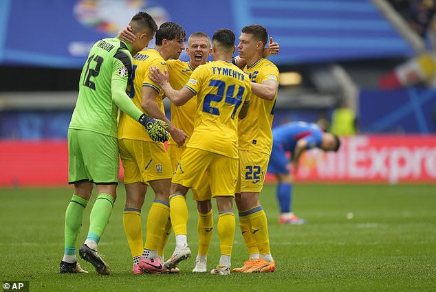 The players gathered in a huddle as they celebrated the win that kept their hopes of qualifying alive